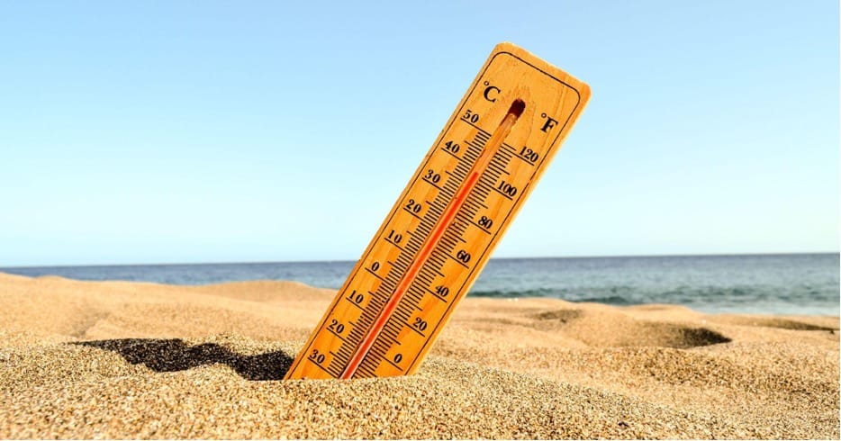 thermometer in the sand at a beach